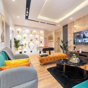 A modern living room with a pool table, a sofa, and a coffee table. - 4th Manor Shortlets (Lekki)