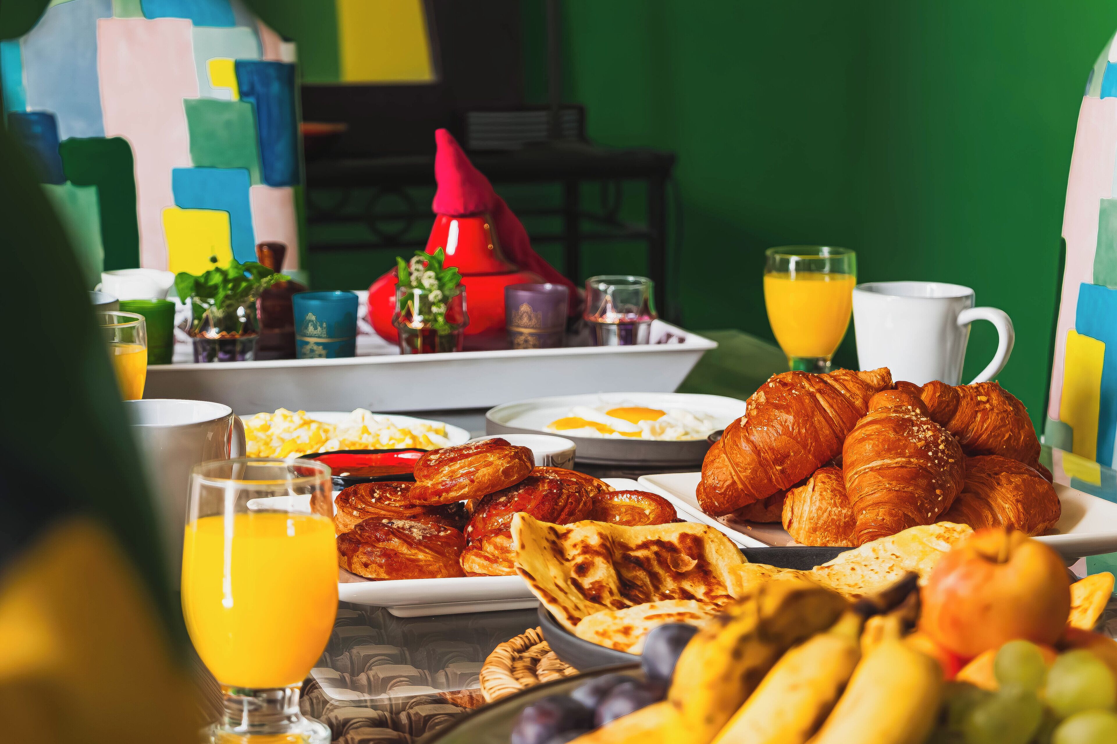 A breakfast spread with various foods and drinks on a table.