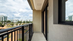 A balcony with a view of a cityscape, featuring modern buildings and a clear sky. - Comfort and Convenience in Brasilia - Get0302 (Guará)