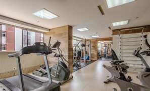 A gym with treadmills, stationary bikes, and weight machines.