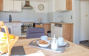 Fridge, stovetop, dishwasher, coffee/tea maker