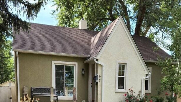 A single-story house with a stone pathway leading to the front door.