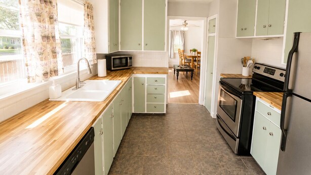 A kitchen with a dishwasher, microwave, stove, and refrigerator.