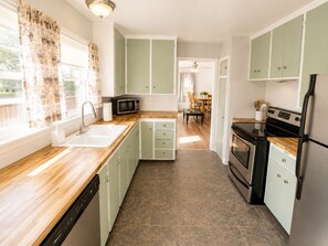 A kitchen with a dishwasher, microwave, stove, and refrigerator. - Spacious Duplex that is pet friendly (Cheyenne)