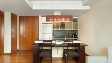 A modern kitchen with a central island, wooden cabinets, and a built-in oven.