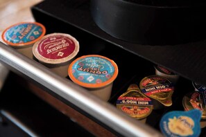 A drawer containing various food items including coffee creamer, chocolate spread, and other condiments.