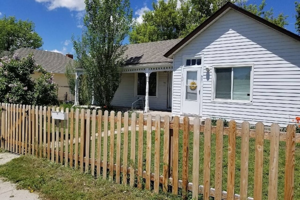 Front of the house. Your entrance on the left. Patio has table and chairs.