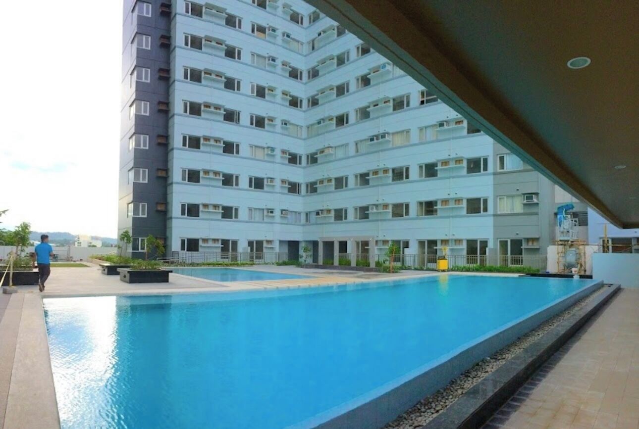A modern apartment building with a swimming pool.