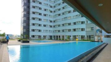 A modern apartment building with a swimming pool.