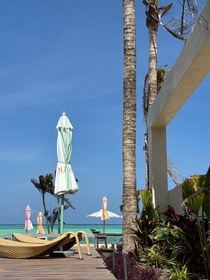 On the beach, white sand, sun loungers, beach umbrellas