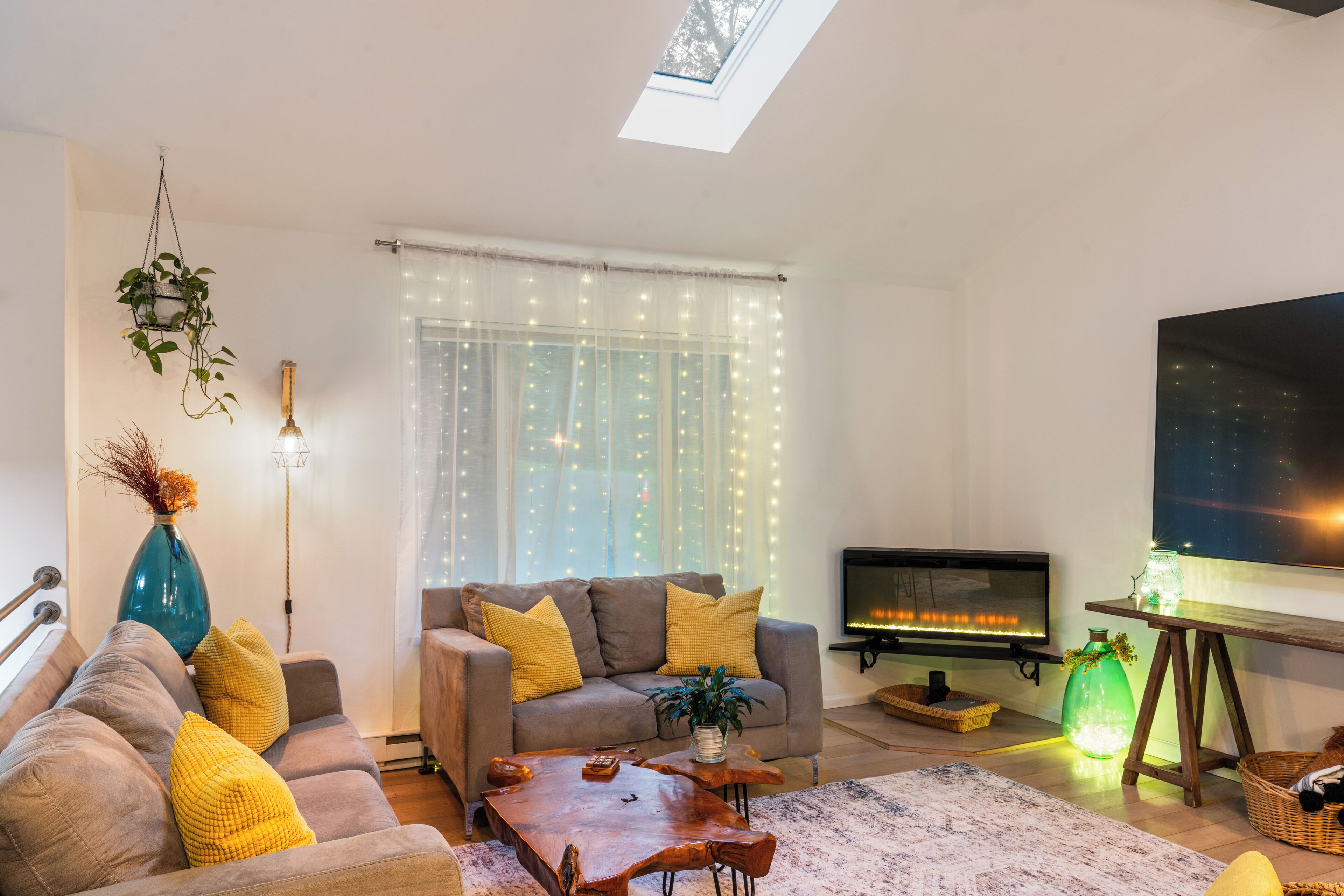 A modern living room with a sofa, coffee table, and a fireplace.