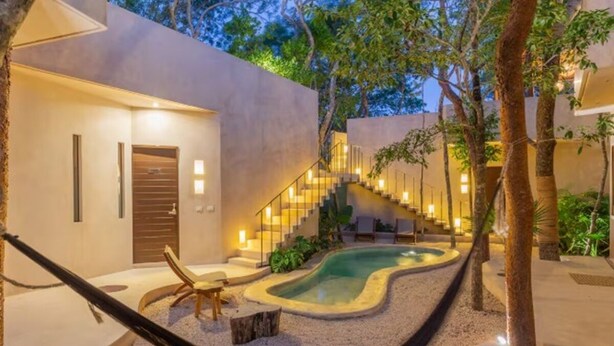 A modern outdoor area with a swimming pool, a hammock, and a staircase leading to an upper level. - APSARA 3 villas condominiums top pools in beautiful Tulum (Tulum)