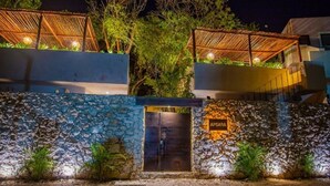 A stone wall with a door labeled "APSAARA" and a covered outdoor area with wooden beams. - APSARA 3 villas condominiums top pools in beautiful Tulum (Tulum)