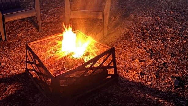 A campsite with a fire pit, two Adirondack chairs, and a covered picnic table. - Cozy Camper setup, off grid (Dunlop)