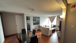 A modern apartment with a dining area, living room, kitchenette, and a separate bathroom. - In condominium with beautiful views (José Luis Bustamante y Rivero)