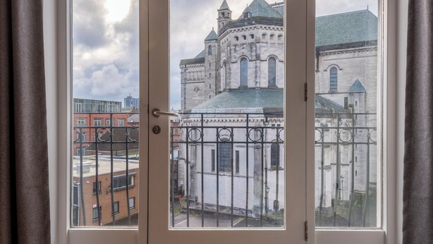 A room with a large window overlooking a historic building.