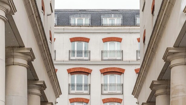 A building with a classical architectural style, featuring a central entrance with a statue, multiple balconies, and a sign reading "SAINT ANNE'S SQUARE". - Modern 1-bed apartment in Belfast’s Cathedral Quarter. (Belfast)