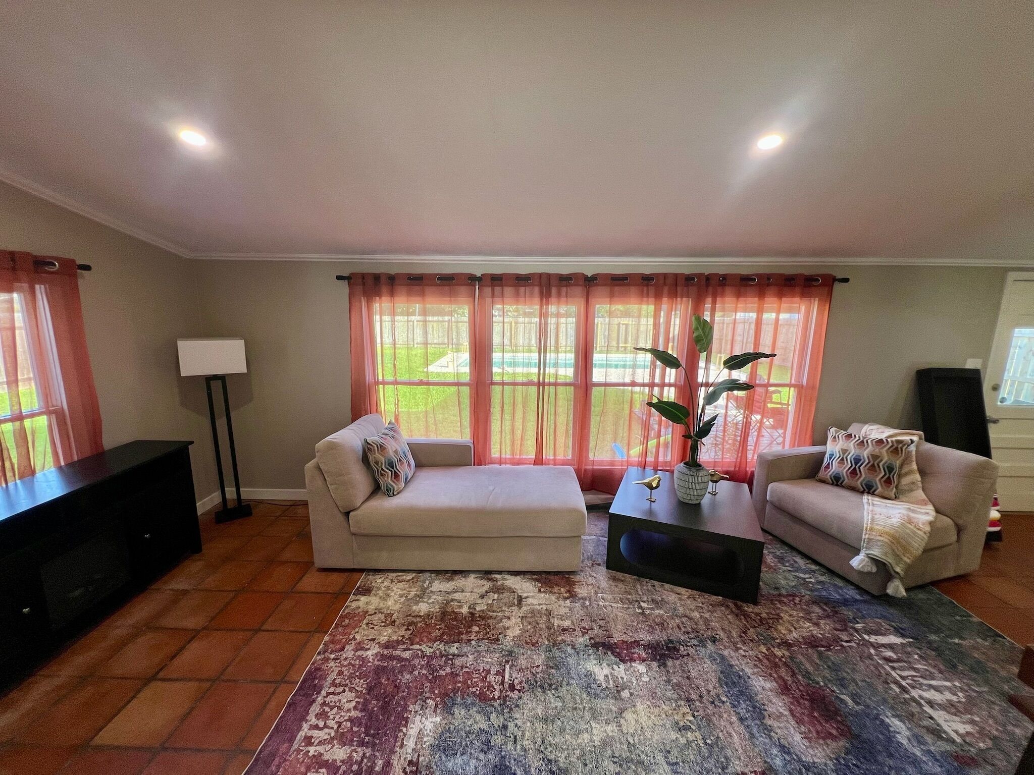 A living room with a sofa, a coffee table, and a TV stand.