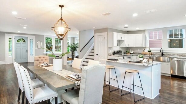 A spacious kitchen with a central island, white cabinetry, and stainless steel appliances. - Springfield Charmer Clean, Spacious,  with WI-FI Close to all! (Jacksonville)