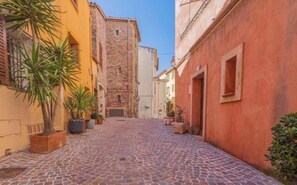 A cobblestone street in a historic town with buildings on either side.