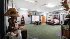 A room with a bed, a desk, a chair, a lamp, a bookshelf, and a window with curtains. - Rustic Retreat Under the Stars - Quiet, Cozy, & Woodsy - high speed WIFI (Fairbanks)
