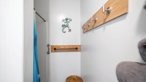A bathroom with a wooden towel rack, a towel rack with hooks, a towel rack with a towel, and a towel rack with a towel. - Rustic Retreat Under the Stars - Quiet, Cozy, & Woodsy - high speed WIFI (Fairbanks)