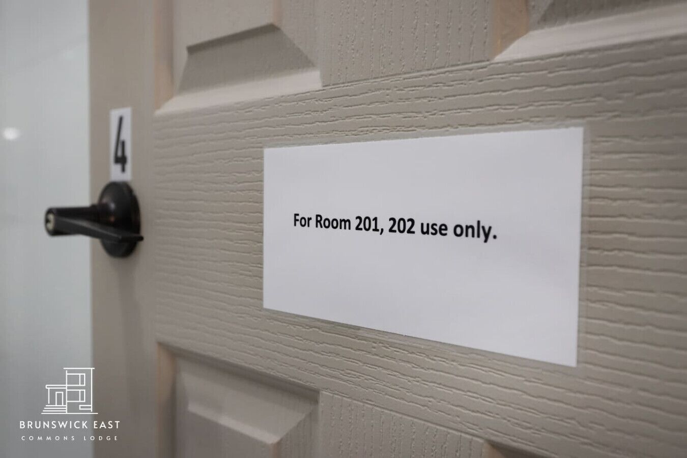A door with a sign that reads "For Room 201, 202 use only."