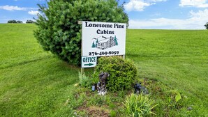 A sign for Lonesome Pine Cabins with an office direction.