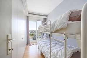 A bunk bed room with a window and a door. - Charming Apartment With sea View and Parking Space (Middelkerke)