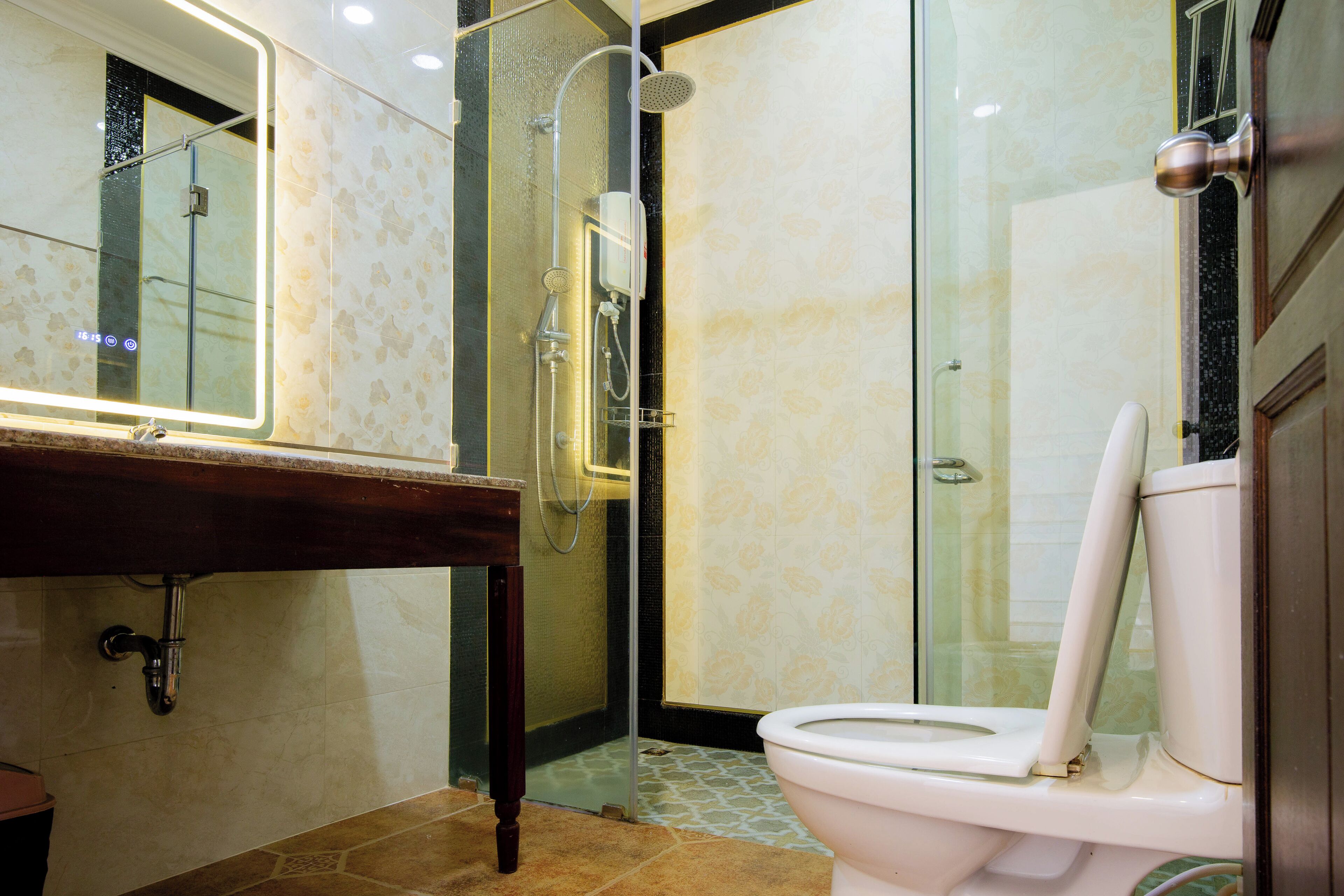 A bathroom with a shower, toilet, and sink.
