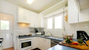 A modern kitchen with white cabinets, a gas stove, a dishwasher, and a blue countertop. - Santa Barbara by Interhome (Calpe/Calp)