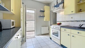 A kitchen with a microwave, stove, and sink. - Ker Eric by Interhome (Tharon Plage)