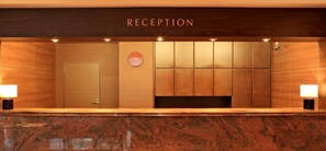 A reception area with a marble counter, a door, and a clock on the wall. - NonsmokingFlat Room for 1 person Bed Room on / Kawaguchi Saitama (Kawaguchi)