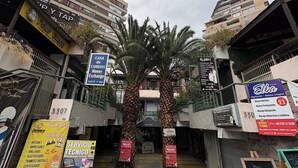 A street view with multiple commercial establishments, including a visible address number 3307, and signs for services like a photo shop and a repair shop. - Apartment with VIP view to the mountain range, and Costanera Center. (Providencia)
