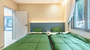 A bedroom with two beds, a window with curtains, and a door leading to another room. - Namhae Orda Pool Villa (Namhae)