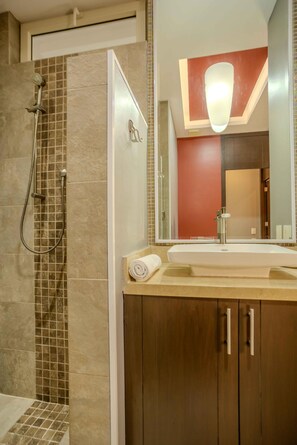 A bathroom with a shower, a sink, and a mirror. - Top Views & Signature Comfort - Walk Everywhere 2BD Condo for rent in Amapas, Pu (Puerto Vallarta)