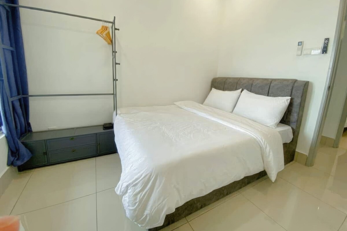 A bedroom with a bed, a wardrobe, and a curtain.