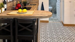 Eine moderne Küche mit Holztischplatte, integriertem Backofen und einer Pendelleuchte.
