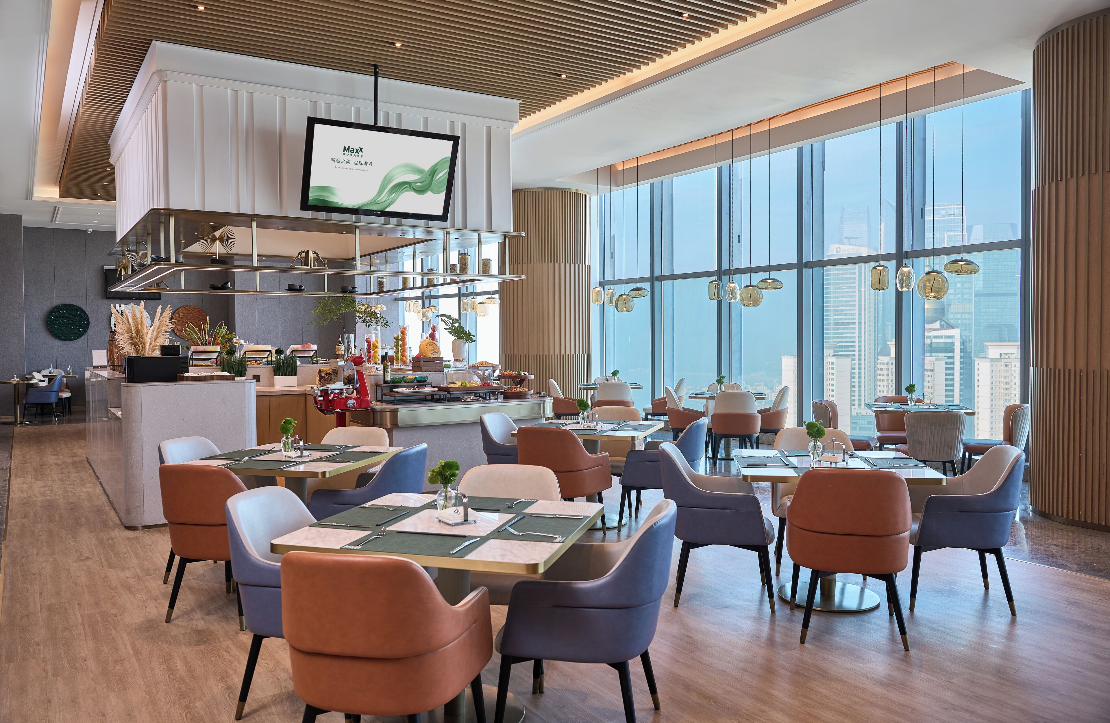 A modern restaurant with high ceilings, large windows, and a city view.