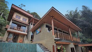 A two-story building with a balcony, a staircase, and a pool area. - Alamora Healing Escape (Sebatu)