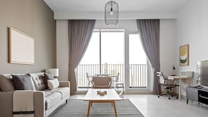 A modern living room with a sofa, a coffee table, and a TV area.