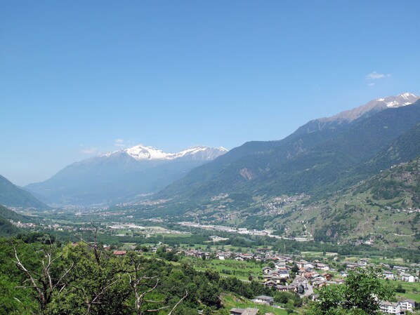 A mountainous landscape with a valley and a small town.
