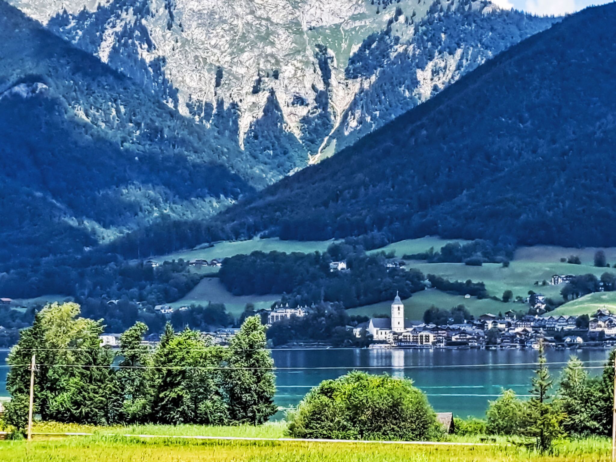 A lakeside village with a prominent church and residential buildings.