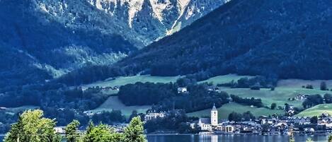 A lakeside village with a prominent church and residential buildings.