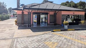A building with a tiled roof, a chimney, and a covered entrance. - Royal Gardens Getaway (Ol Kalou)