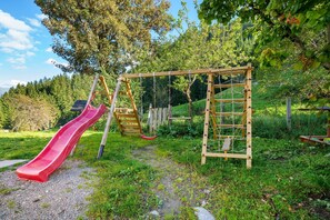 A playground with a slide, swings, and a climbing structure.