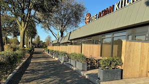 A pathway leading to a building with a sign reading "The Asian Kitchen." - Longstay Achterhoek (Zeddam)