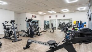 A gym with various exercise machines, mirrors, and a sign reading "BODYCRAFT".