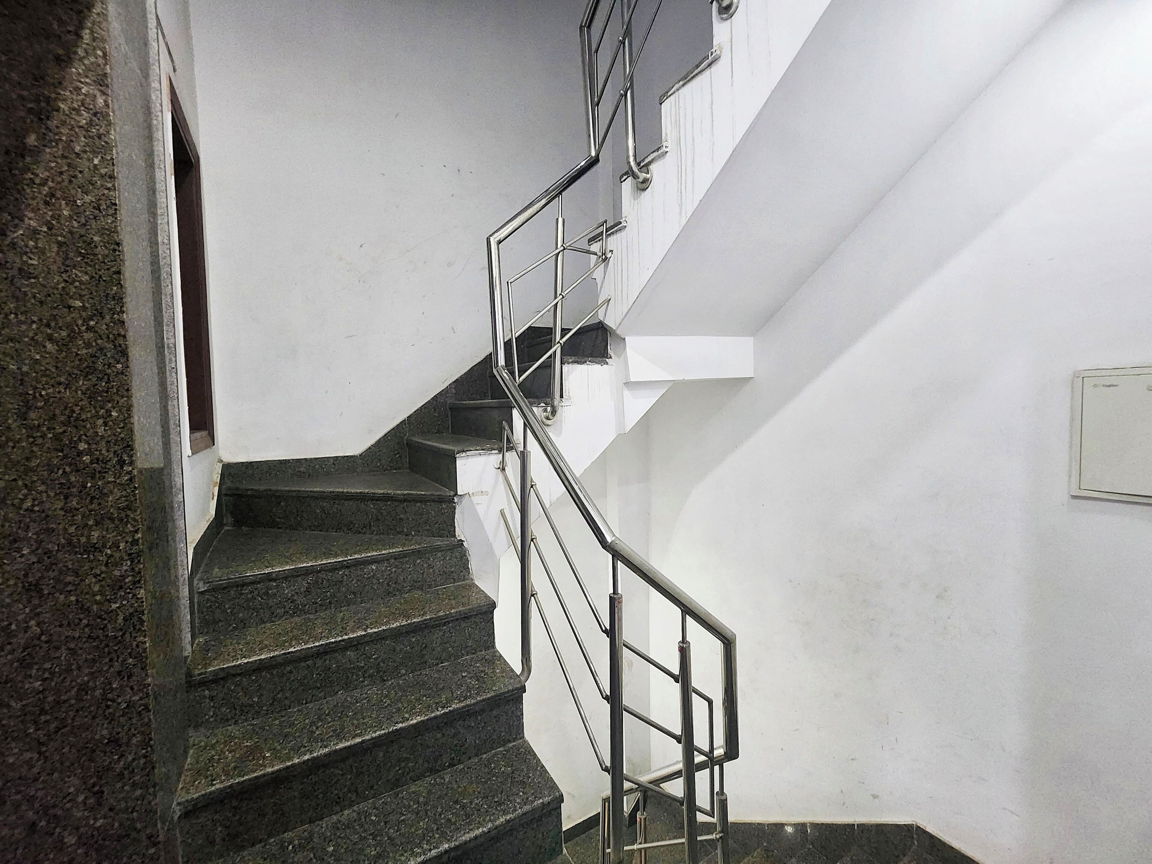 A staircase with metal railings leading to an upper floor.