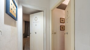 A hallway with doors labeled "Real Umberto I Suite." - Real Umberto I Suite 2 by Wonderful Italy (Palermo)